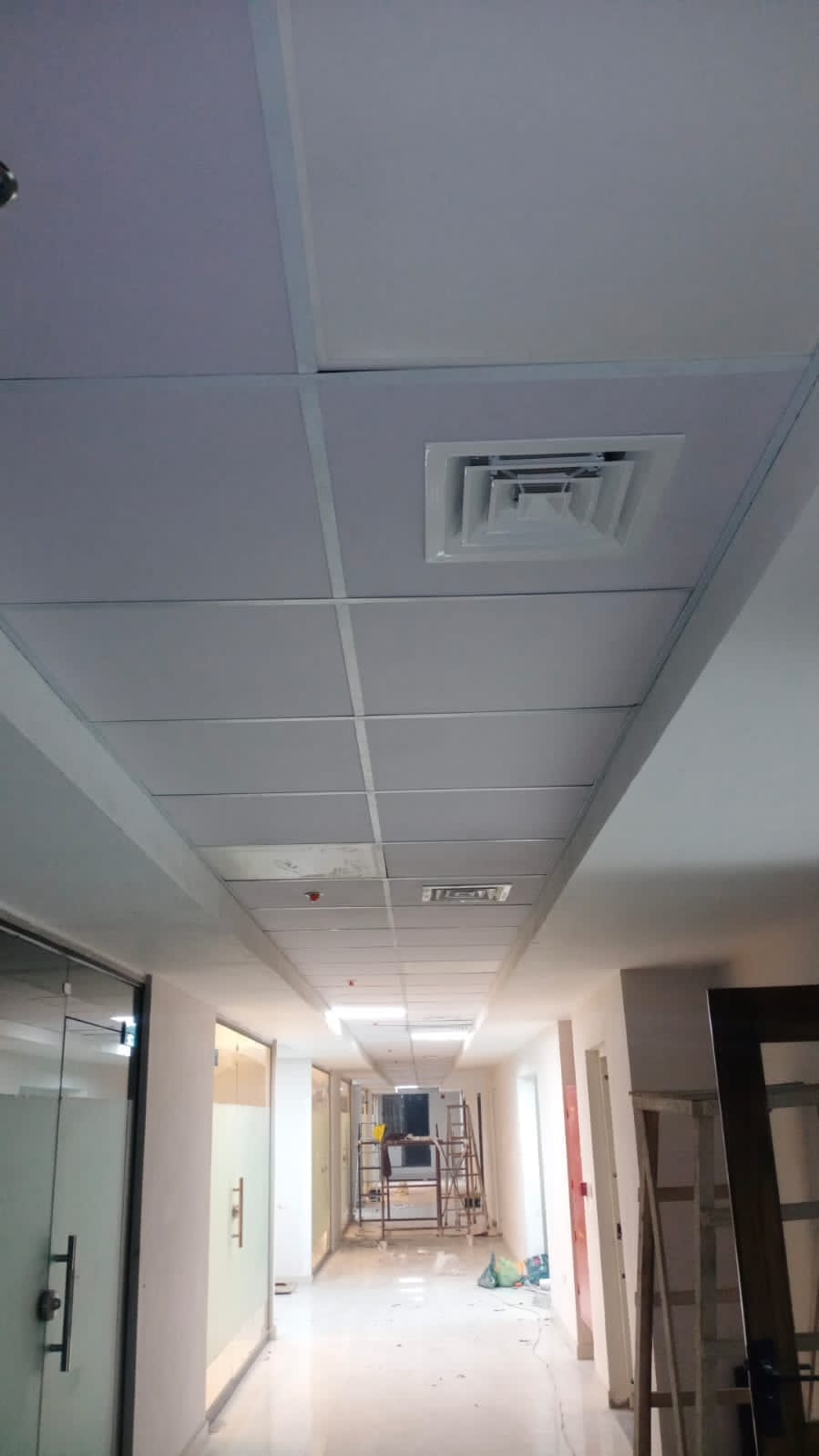 Square ceiling air diffuser in an office corridor