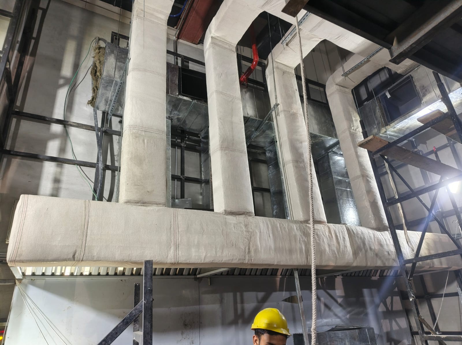Insulated supply ducts installed inside a factory