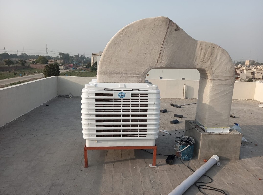 Evaporative cooler installed on a rooftop with an insulated duct