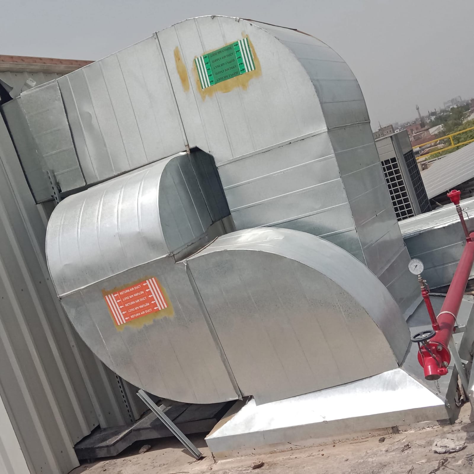 Galvanised supply and return air ducts on a rooftop